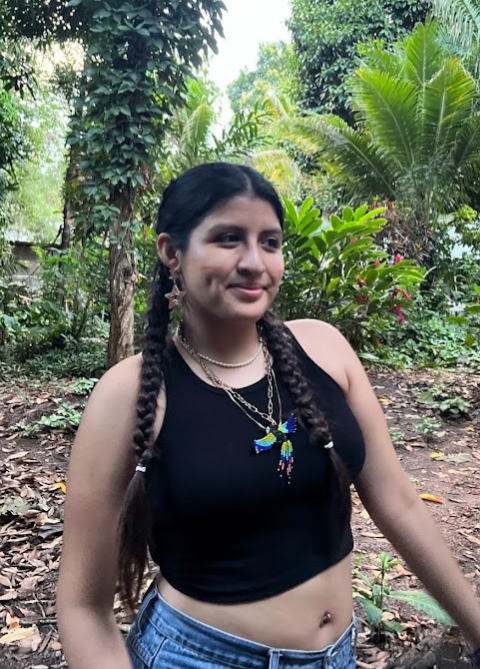 Rosalyn posing in a forest.