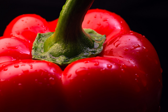 red bell pepper over black background