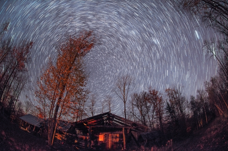 A long exposure shot of stars the movement of stars throughout the night sky.