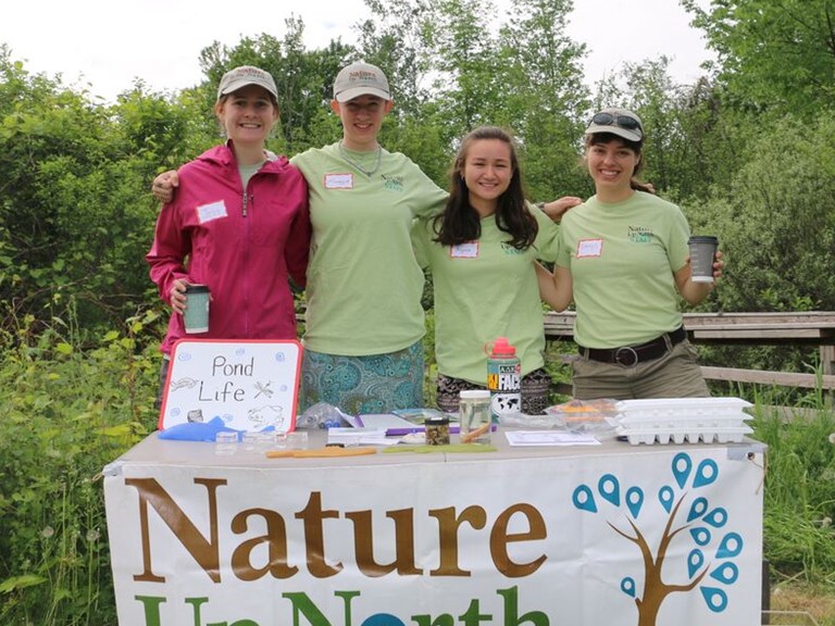 Nature Up North summer interns Jess, Maggie, and Alyssa with Project Manager Emlyn Crocker at Indian Creek Nature Center's Conservation Field Day.