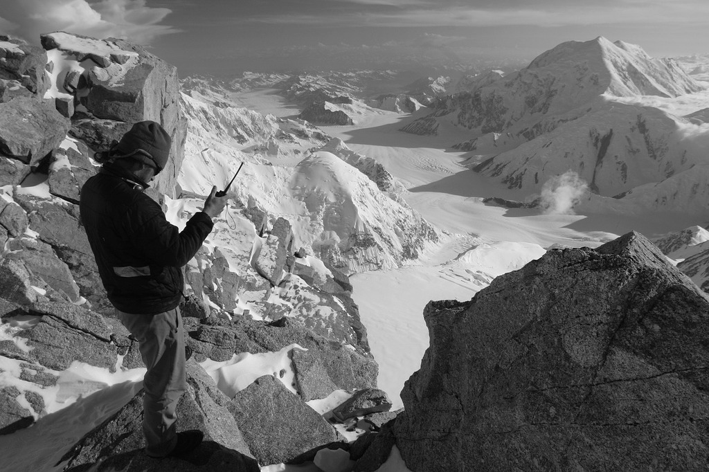 A man on a mountain with a handheld radio